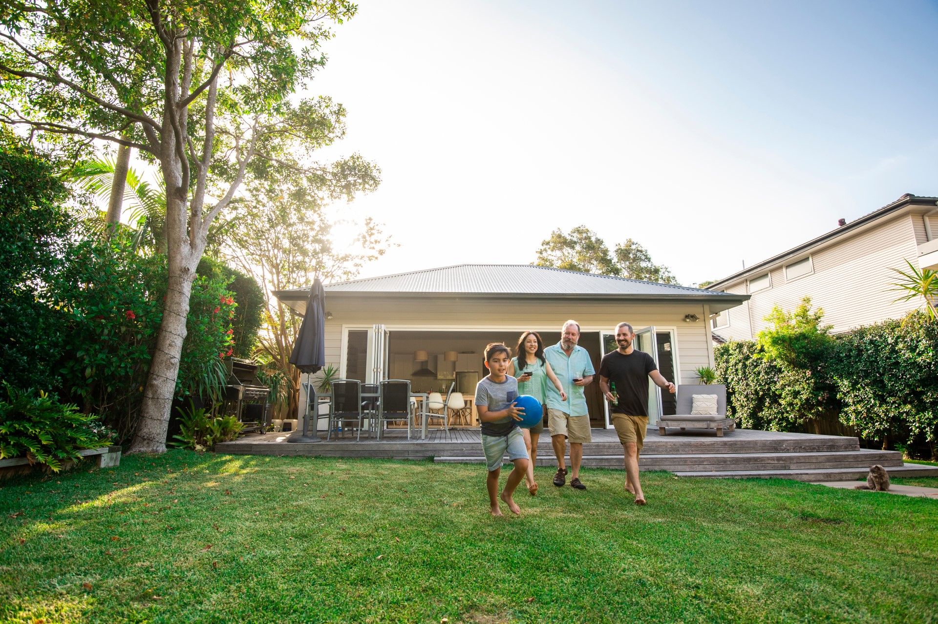 A family walking in front of a house.